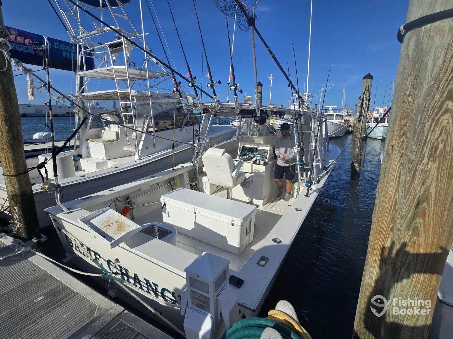 A sport fishing boat named 'Game Changer' docked at a marina, showcasing its exterior and fishing gear.